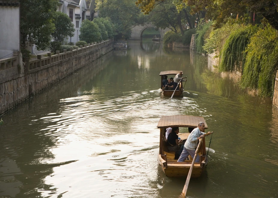 Mit einem Gondelführer auf einem Wasserkanal in Suzhou